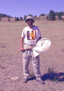 Jeffrey Lockwood hunts for grasshoppers in the field. (Spencer S