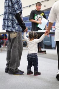A young girl watches on as ballots are passed out