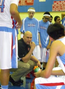 Coach Craig Ferris listens to his players during a time out.