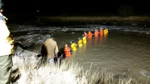 Specially-trained ice rescue volunteers form a line in a grid-style search on the night of Feb. 8 in the Powder River. (courtesy Johnson County Search and Rescue)