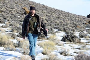 Mark Dantzker walks across the sagebrush while working on a documentary about sage grouse. (Courtesy Gerrit Vyn)