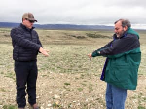 Garry Miller, a vice president with Power Company of Wyoming LLC, right, and Jon Kehmeier, an ecologist hired by the company, describe how strong winds moving over the hills at the Overland Trail Ranch will drive wind turbines across the prairie. Photo by Scott Streater.