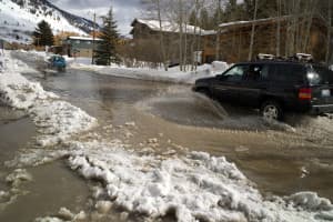 Ski area towns can expect more rain and less snow as a result of climate change, leading to scenes like this one in Jackson, a report funded by a nonprofit organization says. In Jackson Hole, many local businesses and organizations try to be green, yet they rely heavily on transportation systems that have large carbon footprints. (Angus M. Thuermer Jr./WyoFile)