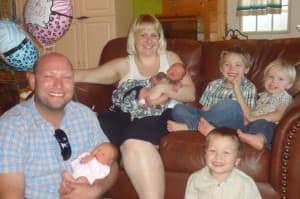 Feike van Dijk and his wife Noelle Wiemann van Dijk hold their twins Sabine and Ephraim. Their sons Zephan Eryck and Noah Drye, shown here sitting on the couch, died in the fire. Their eldest son Able Leif is below. (Courtesy van Dijk family)