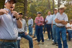 Mark Donner of Trihydro Corporation explains the topography at Meadowlark Lake, a potential reservoir site. Jason Mead is behind him. Wyoming Water Development Commission Vice Chairman Sheridan Little is center, in the red plaid shirt. Sen. Curt Meier is to Little's left along with, commissioner Bill Resor, former Sen. John Hines and Suzsy Eklund, wife of Rep. John Eklund. (Angus M. Thuermer Jr./WyoFile)