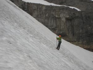 A member of theJenny Lake Climbing Rangers helps take measurements on the Schoolroom Glacier in 2014. (courtesy Grand Teton National Park)