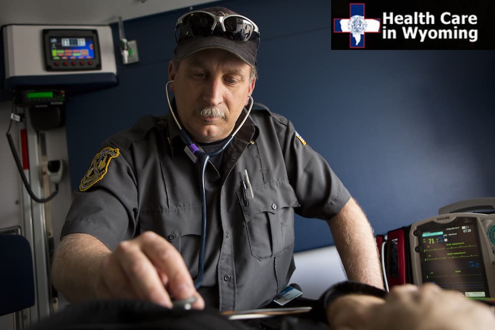 EMS employee uses a stethoscope