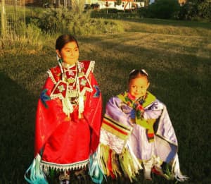 Amarie Swallow (right) in her jingle dress. Children on the Wind River Indian Reservation face obstacles to health care, which can determine their "life course." (photo by Matthew Copeland/WyoFile)