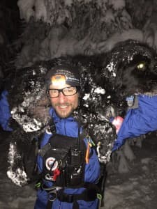 Jake Urban carries a dog during a training exercise with Teton County Search and Rescue. (courtesy Teton County Search and Rescue)