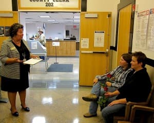 Albany County Clerk Jackie Gonzales explains the process for applying for a marriage license to Teresa Bingham and Linda Mahaffey. (WyoFile/Gregory Nickerson)