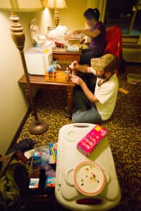 In this excursion to Kemmerer in 2014, DeVivo helps collect and process mule deer blood for migration and nutrition studies. Field work involves helping colleagues and the initial processing of samples, sometimes in far-flung motel rooms with pizza on the dinner menu. (Angus M. Thuermer Jr./WyoFile)