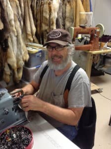 Merlin Heinze sews a buffalo hide into a coat for the movie "The Hateful Eight." (courtesy)