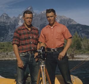 Frank and John Craighead in a raft in front of the Tetons. The twin brothers advanced biology by using radio telemetry to track grizzlies in Yellowstone. Grizzly bears weren't found along the Snake River when the brothers took this picture, but they populate the area today. (Craighead Institute)