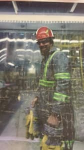 Sean Seems, who left Peabody Energy's North Antelope Rochelle mine in 2015 to work at a gold mine in Alaska, stands behind a plastic screen. (Courtesy)