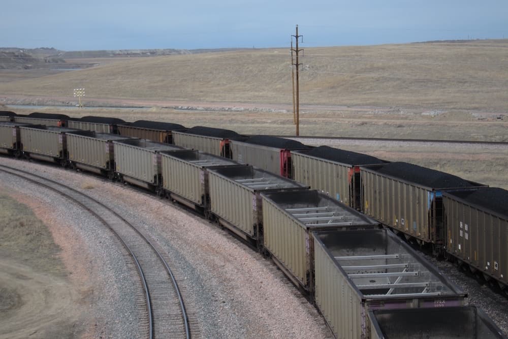 One loaded coal train rolls out of Arch Coal's Black Thunder mine as an empty train is in queue. Arch, now under Chapter 11 Bankruptcy, promises to keep commitments to retirees. (Dustin Bleizeffer/WyoFile)