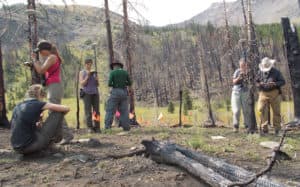 Archaeological teams haul high-tech equipment, often deep into the back country, to record precise artifact locations and other critical data. (Courtesy of Larry Todd)