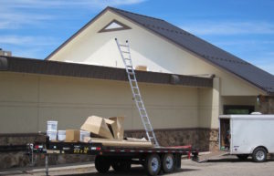 An un-manned ladder rests on a work trailer at a Casper restaurant. While Wyoming worker's comp division guesses that 120 to 200 of the 12,000 new claims filed each year are fraudulent, they know for sure that employers are delinquent in paying premiums to the tune of $3.3 million. (Dustin Bleizeffer/WyoFile)