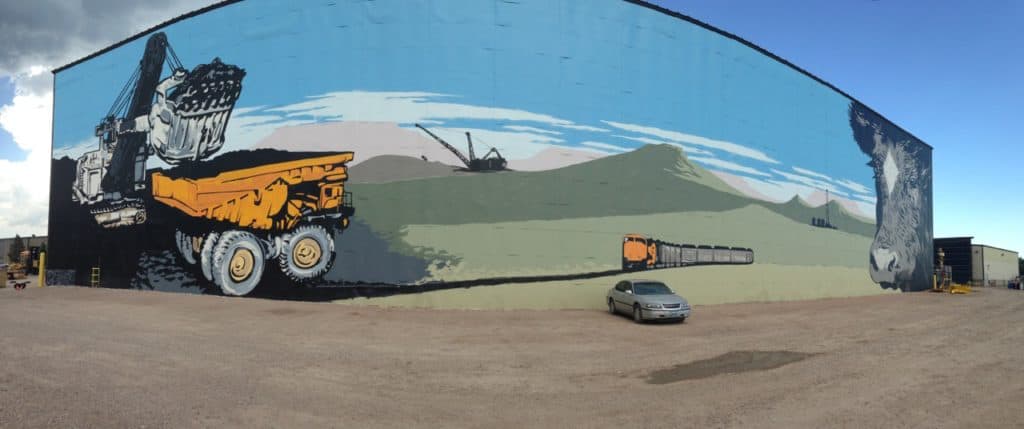 Wyoming's reliance on coal revenues is writ large in this mural at L&H Industrial in Gillette. It symbolizes the size, scope and influence coal mining has on the state and the resulting disruption a downturn in coal revenue has had. (Dustin Bleizeffer/WyoFile)