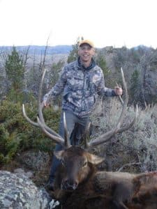 Hunter Emmett Nelson shot this elk on public land that would become private under the land exchange proposal. Critics say the swap, which a top Wyoming official recommends be completed, would be detrimental to hunters and other recreationists. (Jeff Muratore)