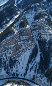 The Cow of the Woods avalanche path looms above U.S. 191 in Hoback Canyon in this aerial photo, which also shows the smaller Calf of the Woods track. WYDOT has placed O’Bellx exploders in both paths so workers can provoke snowslides from afar. The new O’Bellx devices can be retrieved by a helicopter for maintenance or refueling. (WYDOT)