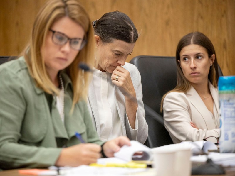 Plantiffs and lawyers sit behind a table in the Teton County Court House