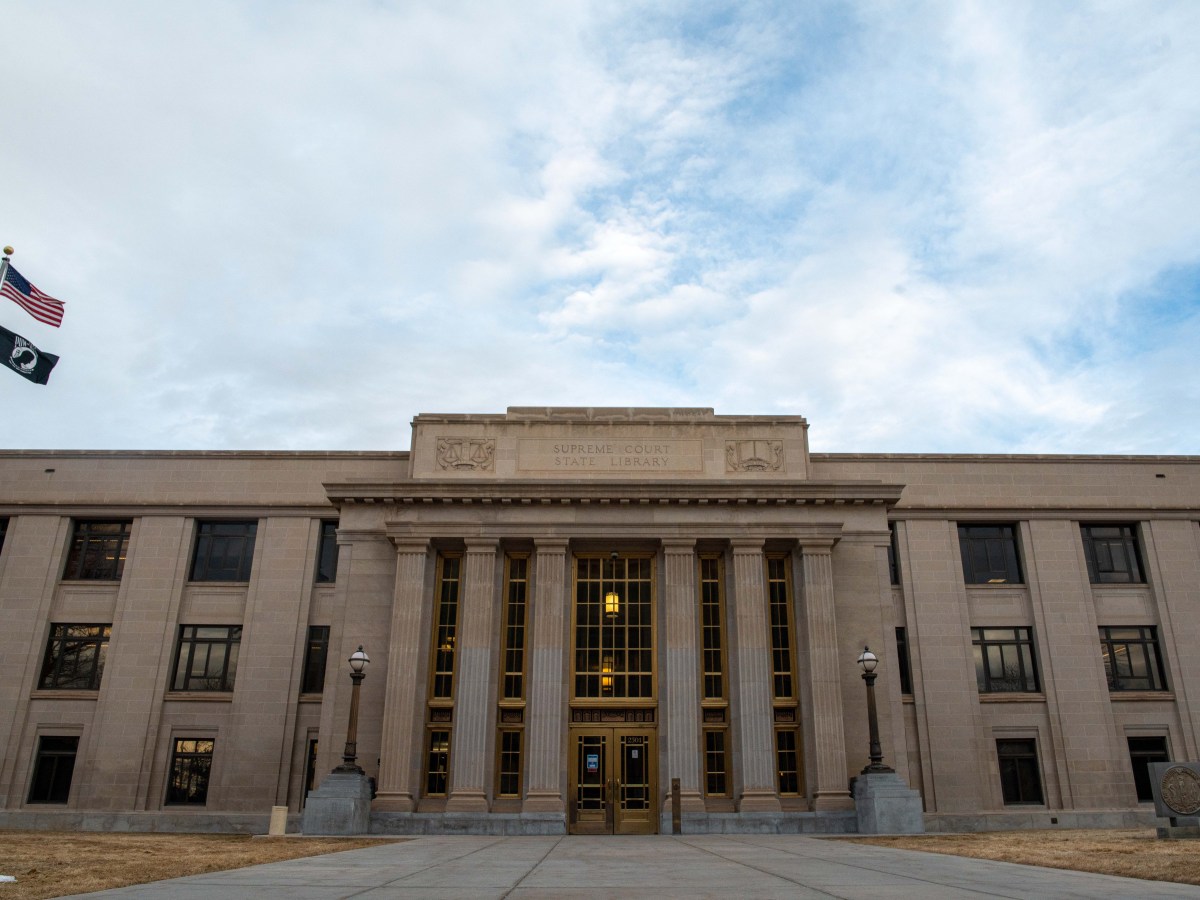 The front of the Wyoming State Supreme Court building on a partially cloudy and windy day