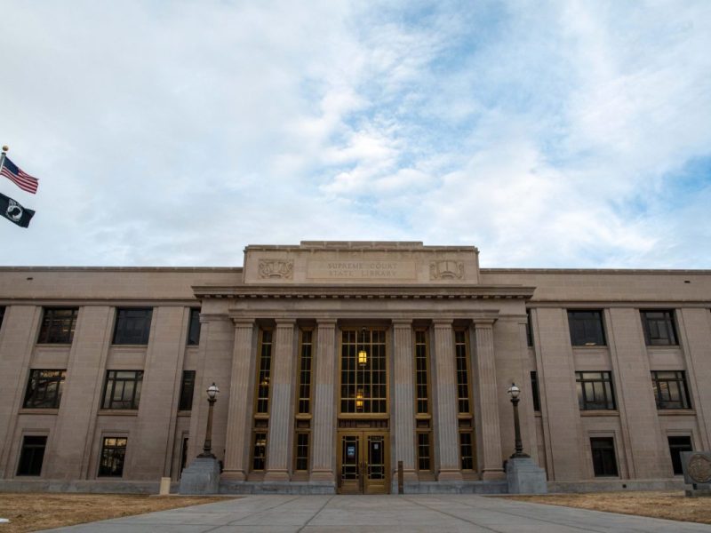 The front of the Wyoming State Supreme Court building on a partially cloudy and windy day