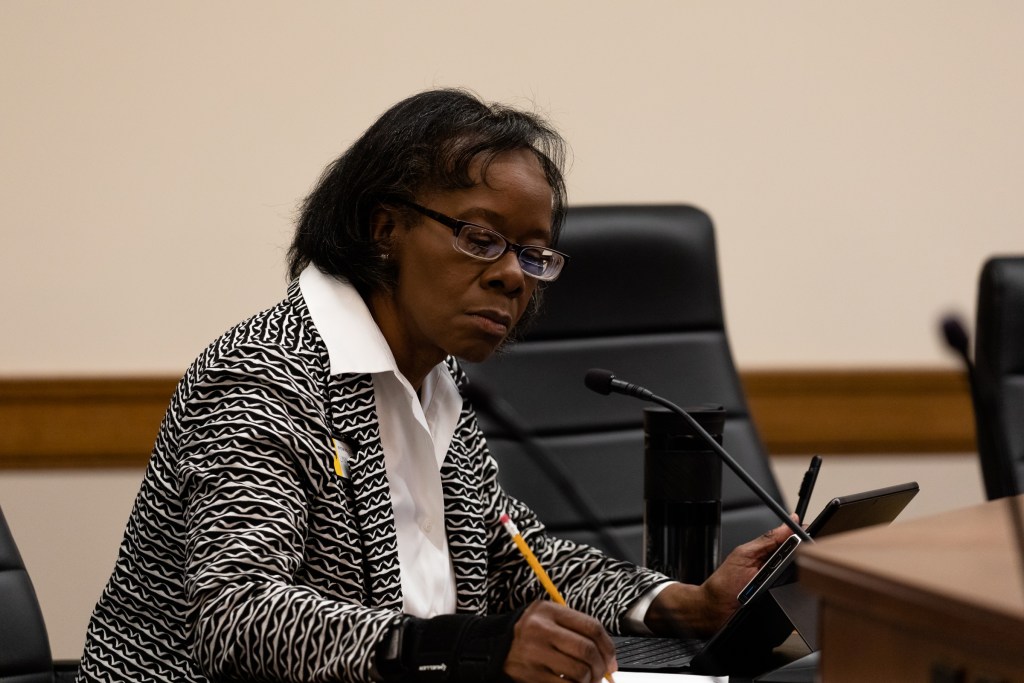 Sen. Lynn Hutchings sits at a desk