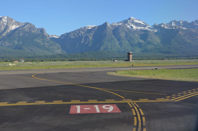 A runway in Jackson with a view of the Teton Mountains