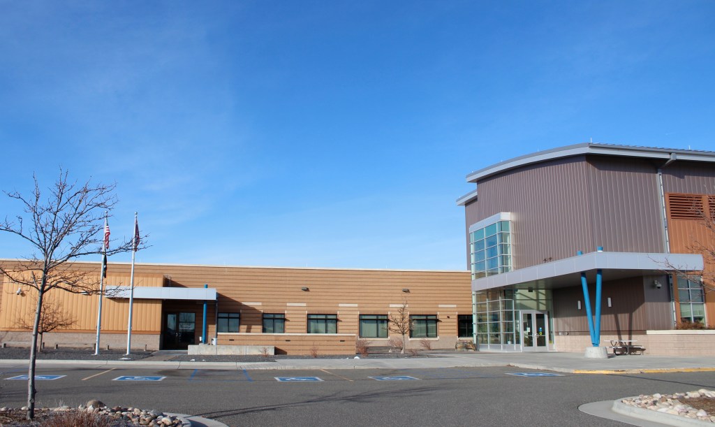 A tan and brick building on a sunny day