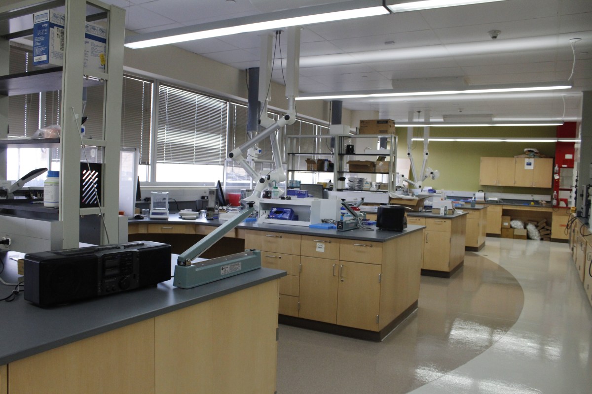 Lab tables are littered with boxes and small mechanical devices