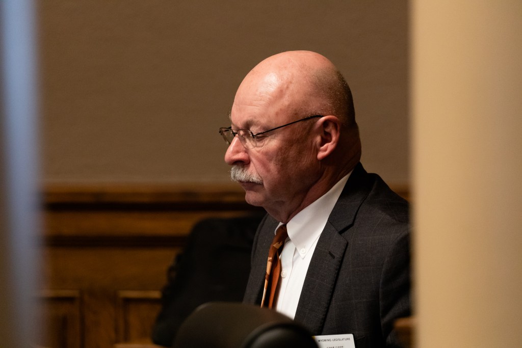 Sen. Cale Case sits at a desk