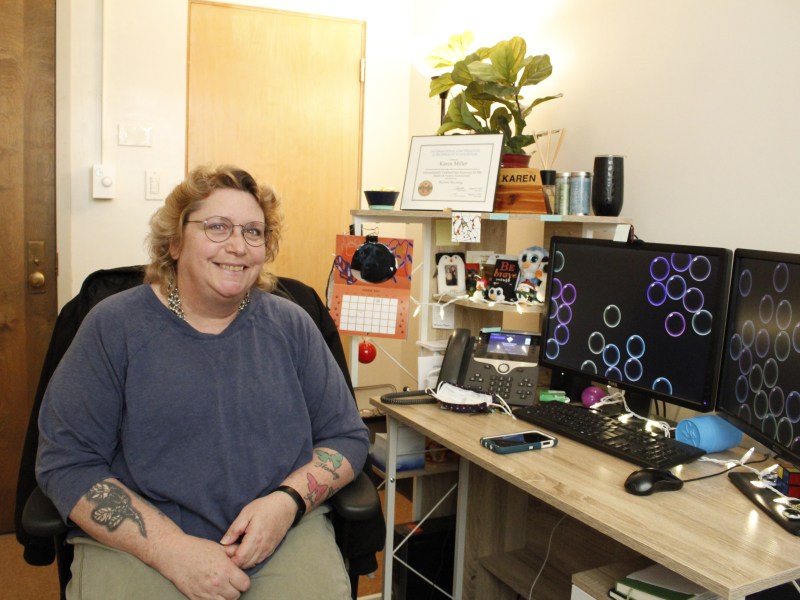 Karen Miller sits in her off