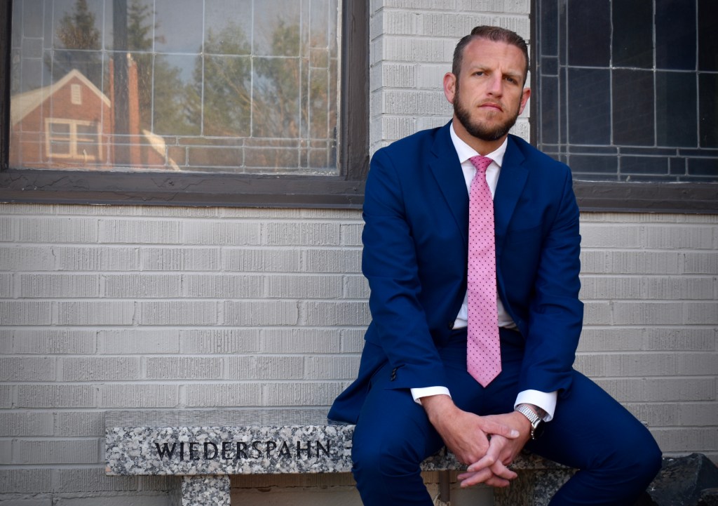 Levi Wardell sitting in front of the funeral home in Cheyenne