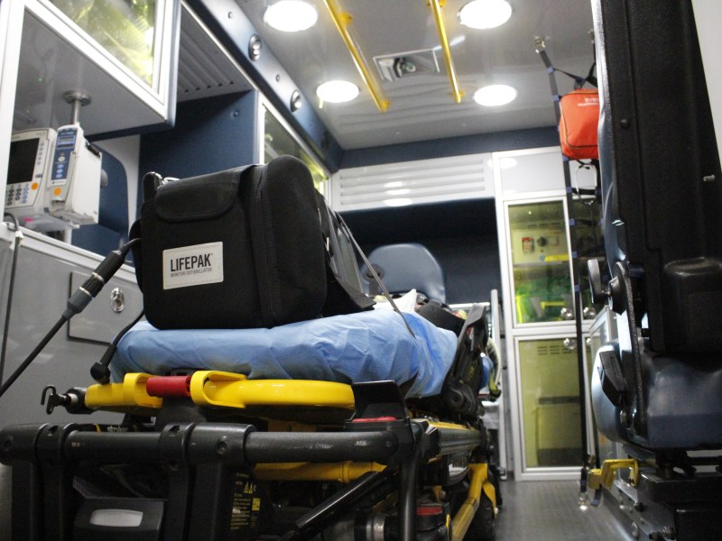 The back of an ambulance, including a stretcher and medical supplies
