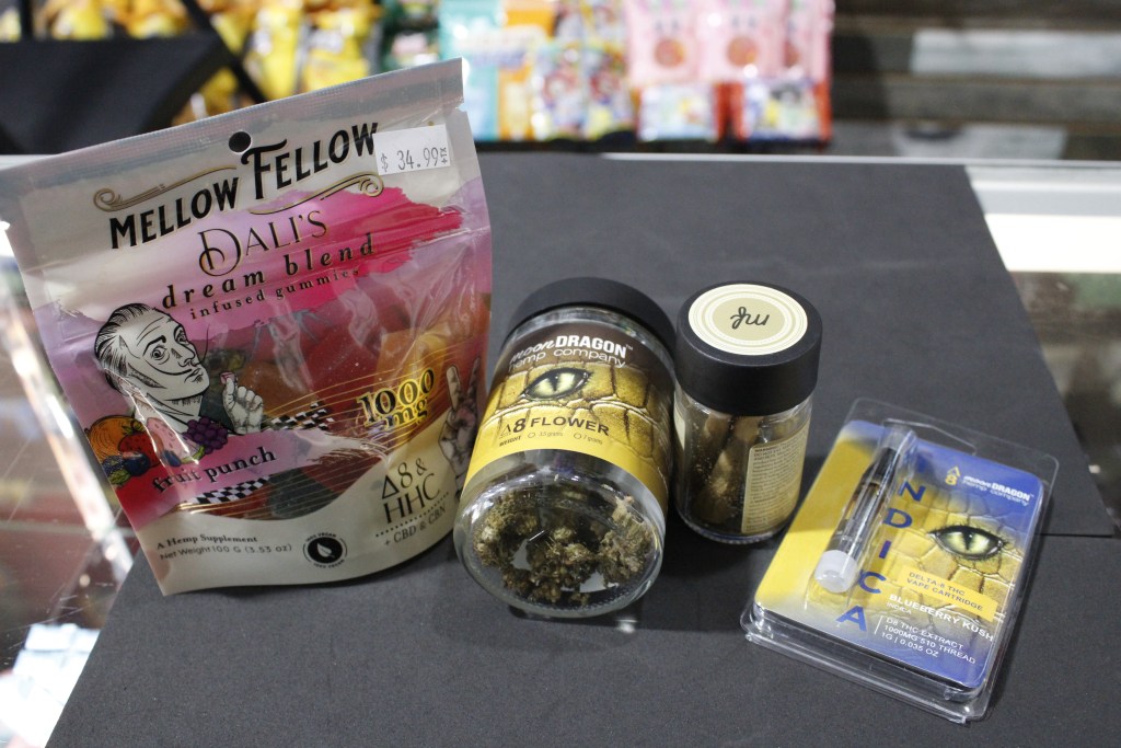 Delta-8 gummies, flower, pre-rolls and vape pen are set out on a counter