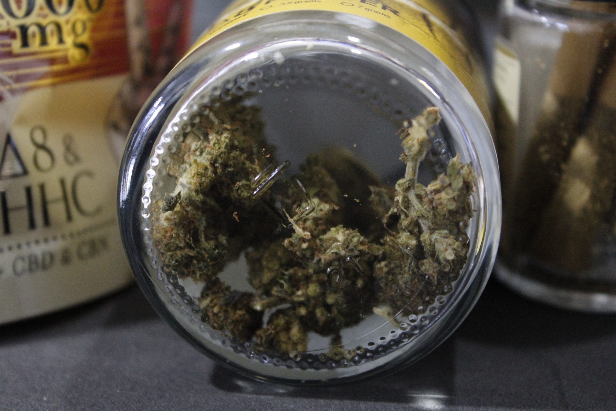 The underside of a jar filled with delta-8 flower