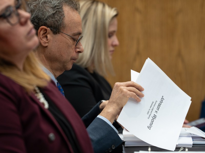 Maudlin leafs through papers, the top of which says Johnson v. Wyoming