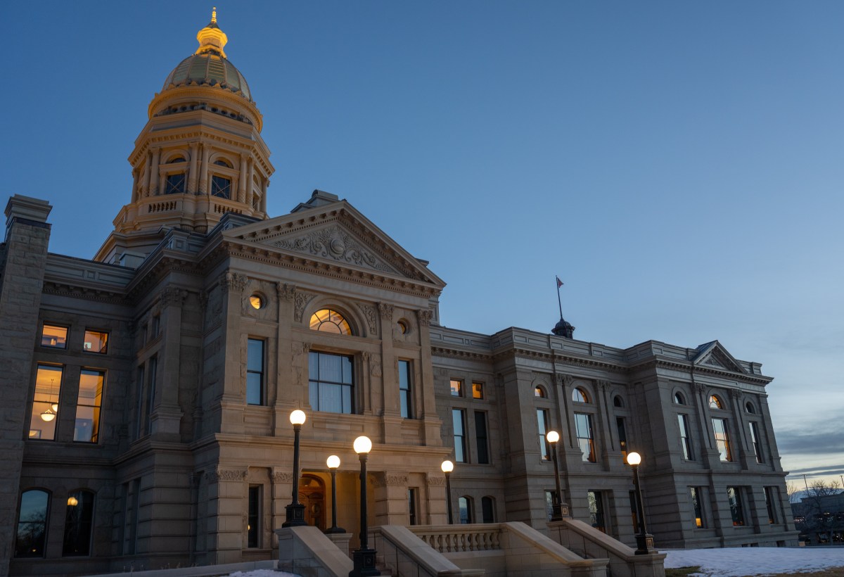 The Capitol in Cheyenne at dusk with golden lights shining out into the fading daylight. (