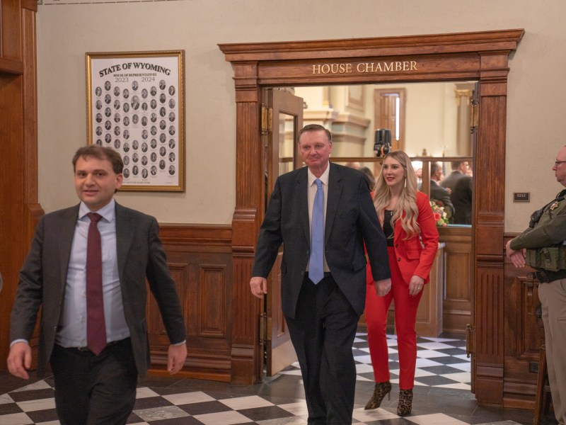 The three walking out of the House Chamber in suits