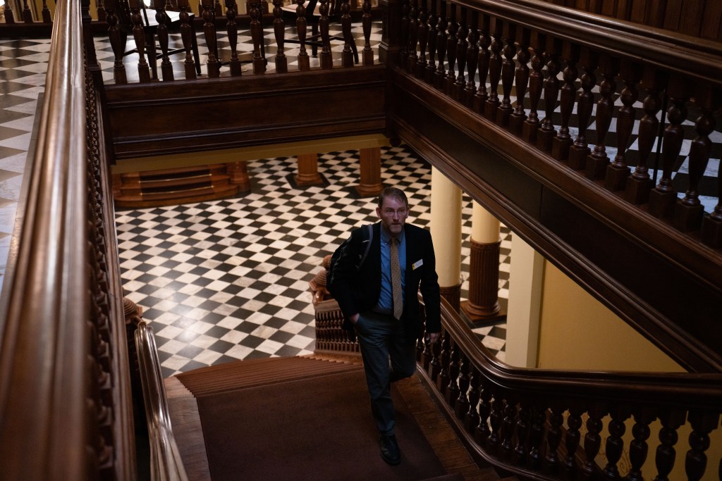 Senator Chris Rothfuss walks up the steps at the Wyoming capitol