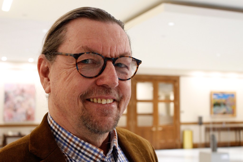Ralph smiles for a portrait in the extension of the capitol building in Cheyenne