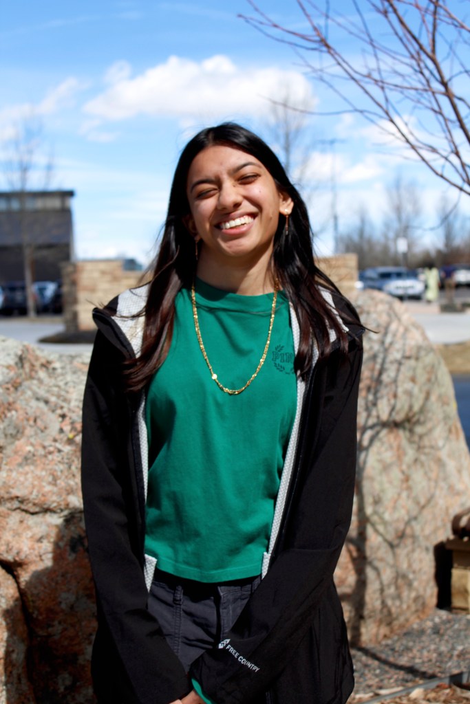 Priya smiles in the sunshine