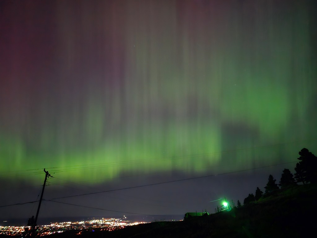 Green and pink streaks in the sky above Casper
