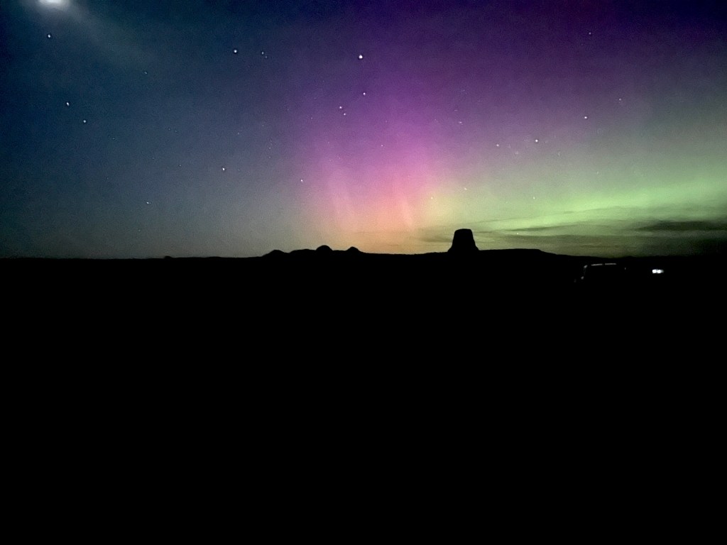 Aurora borealis behind Devils Tower silhouette