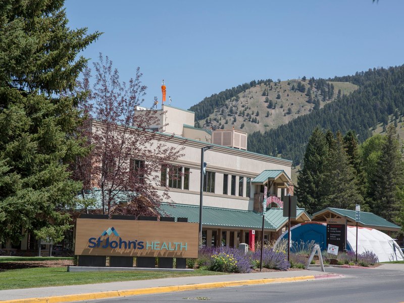 A hospital building with a sign out front saying "St. John's Health"