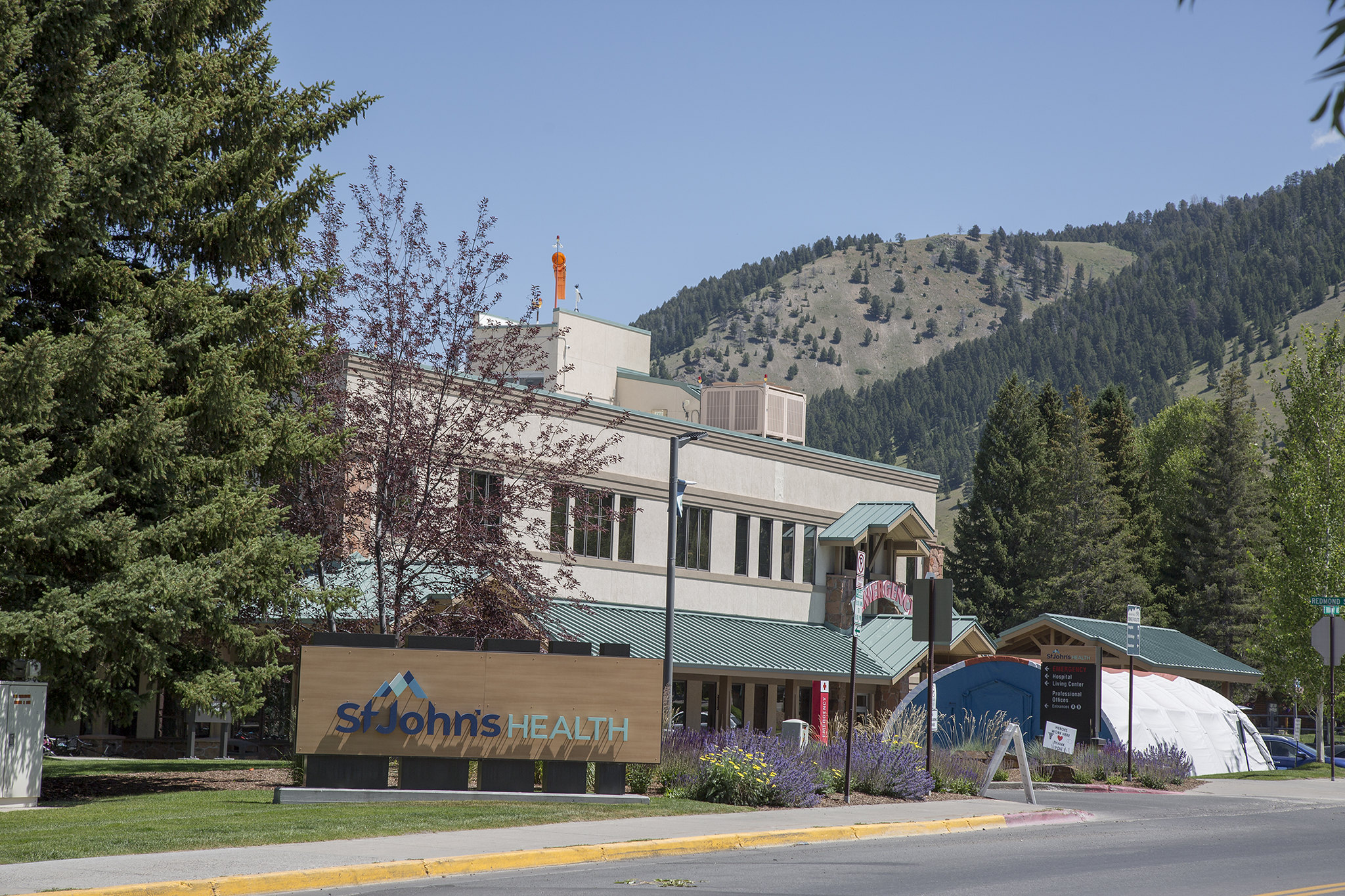 A hospital building with a sign out front saying "St. John's Health"