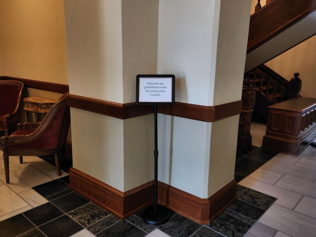 A sign that says "Firearms are prohibited in the Wyoming State Capitol"
