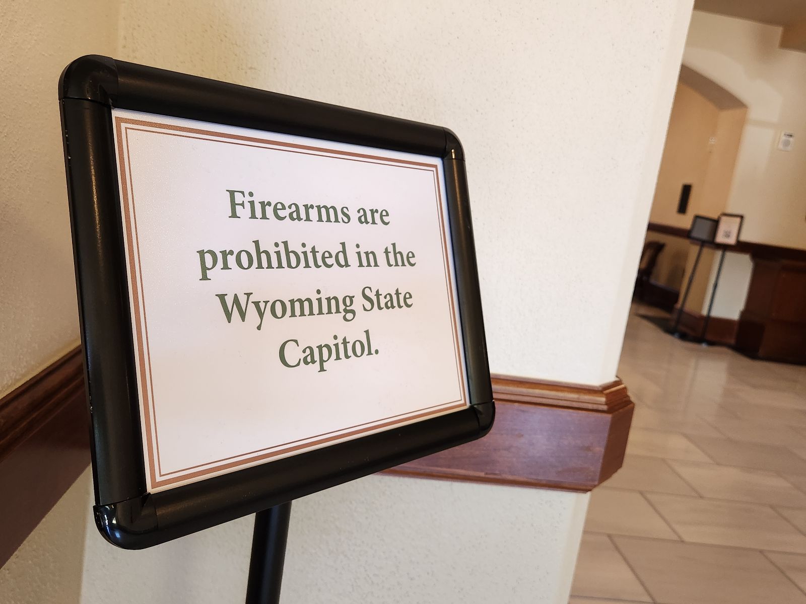 A sign that says "Firearms are prohibited in the Wyoming State Capitol"
