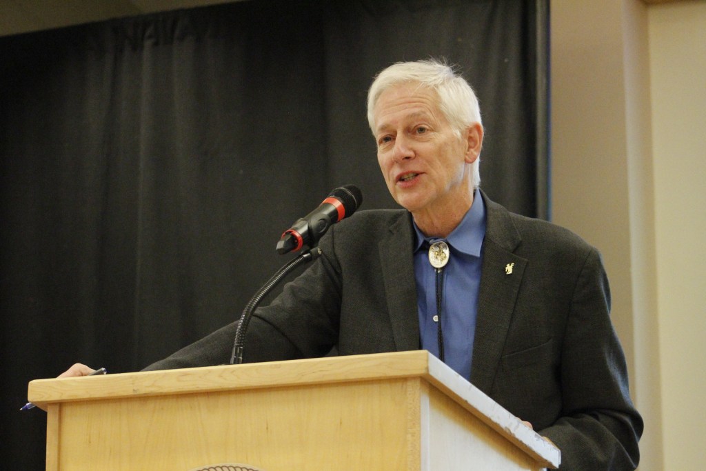 A man stands at a podium